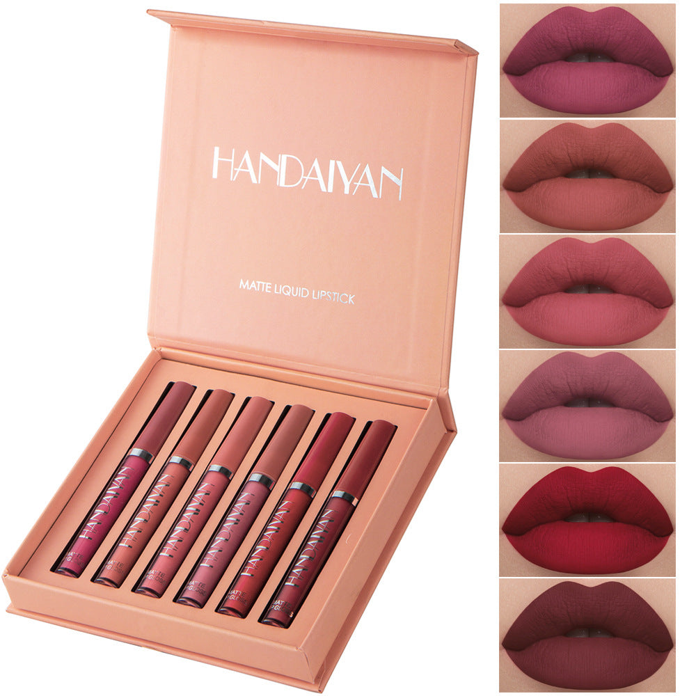 Set of lipsticks in a box with color swatches on the side.