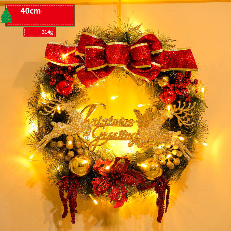 Decorative Christmas wreath with lights and reindeer on a plain background