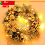 Decorative Christmas wreath with gold ornaments and lights on a warm background