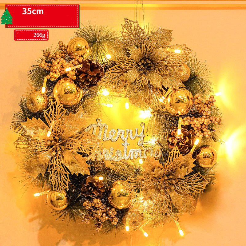 Decorative Christmas wreath with gold ornaments and lights on a warm background