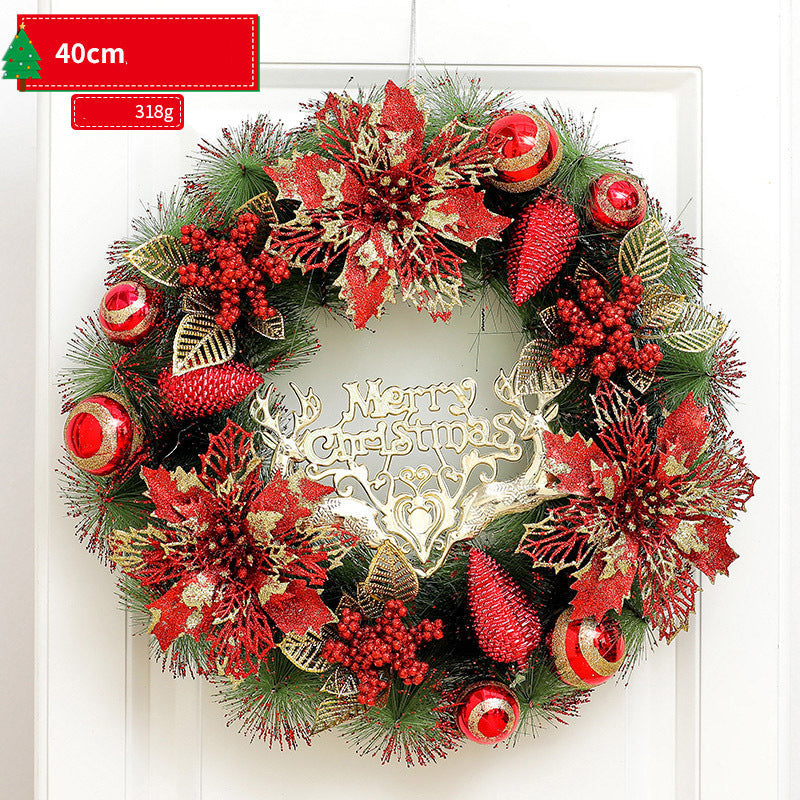 Decorative Christmas wreath with red and gold flowers on a white background