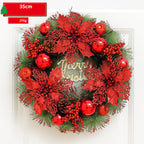 Decorative Christmas wreath with red flowers, berries, and gold 'Merry Christmas' text on a white background.