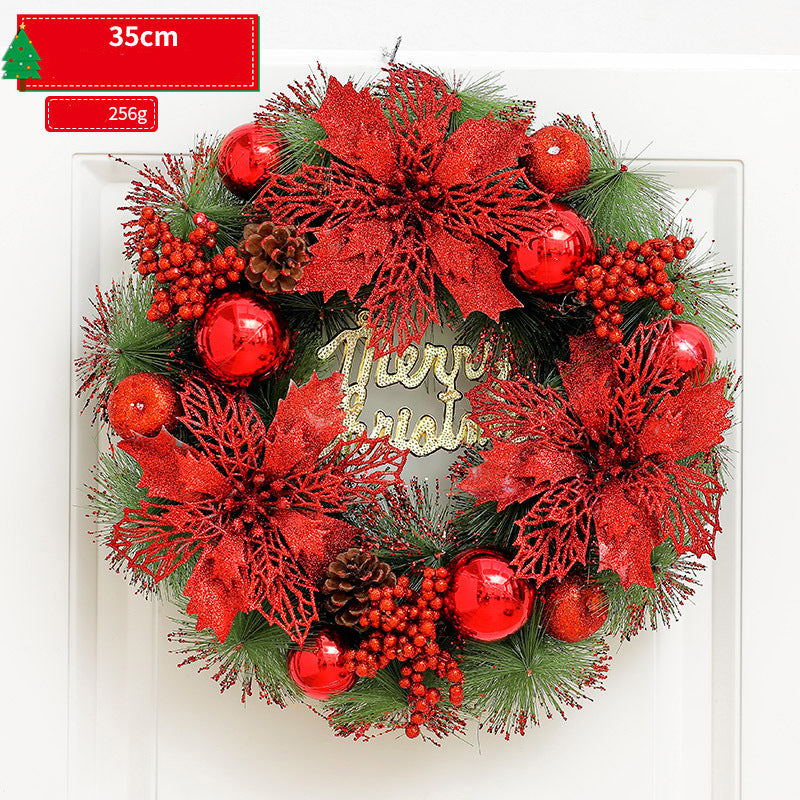Decorative Christmas wreath with red flowers, berries, and gold 'Merry Christmas' text on a white background.