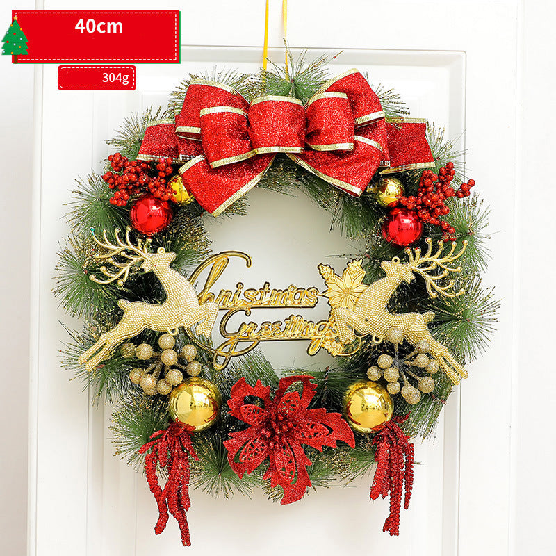 Christmas wreath with red ribbons, gold reindeer, and 'Christmas Greetings' sign on a white background.