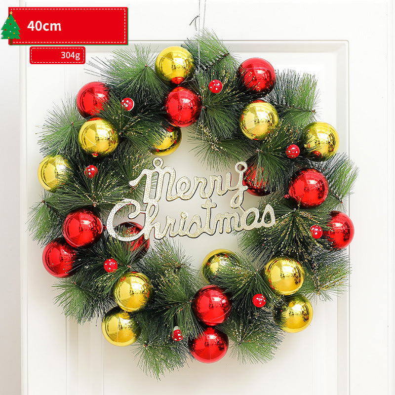 Christmas wreath with red and gold ornaments on a white door