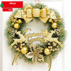 Decorative Christmas wreath with gold reindeer, bow, and ornaments on a white background