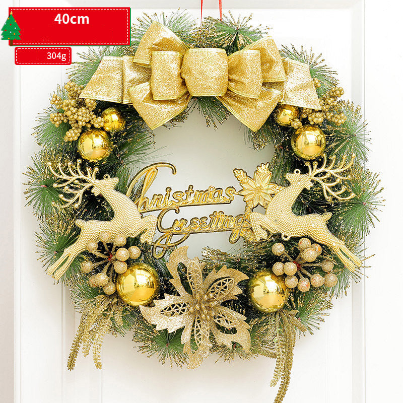 Decorative Christmas wreath with gold reindeer, bow, and ornaments on a white background