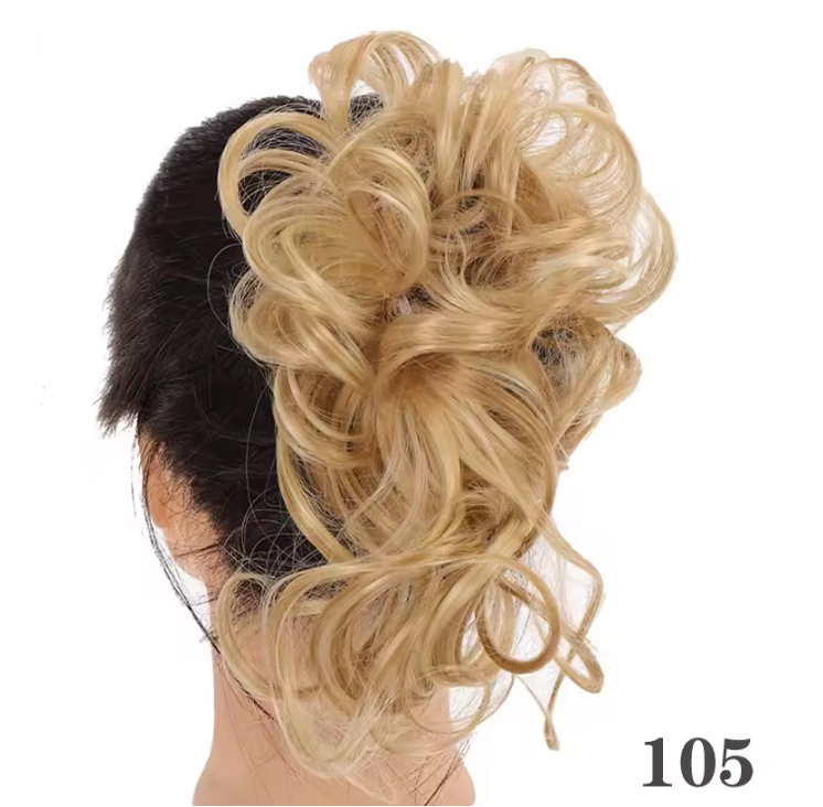 Blonde hairpiece styled in an updo on a person with a white background