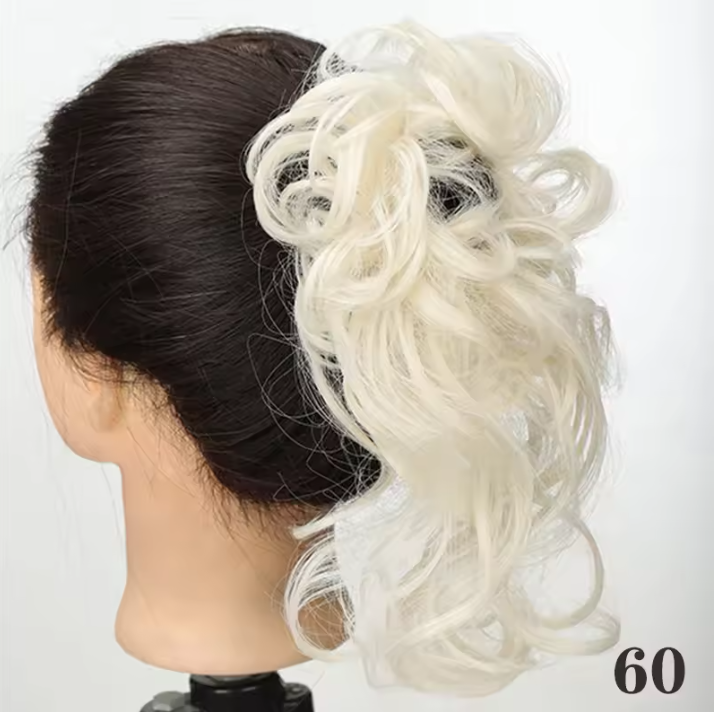 Mannequin head with black hair and a white ponytail extension on a white background